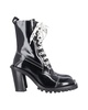 laced-up combat boots in black patent leather